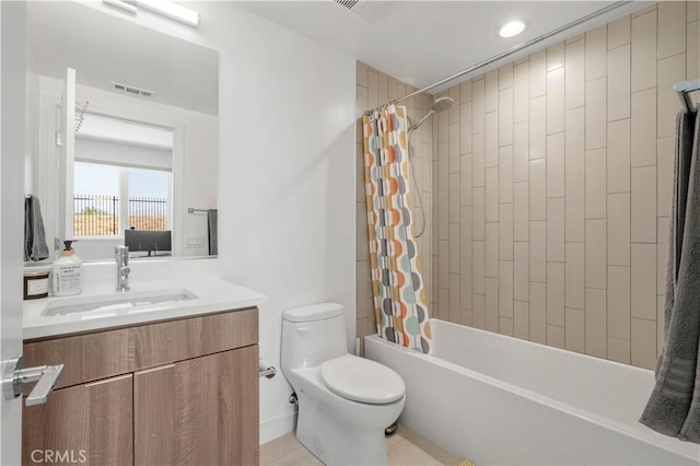 full bathroom featuring tile patterned flooring, vanity, shower / tub combo with curtain, and toilet