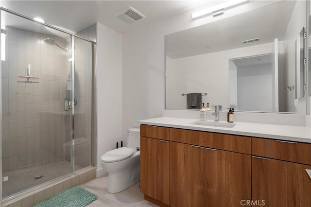 bathroom with tile patterned floors, vanity, toilet, and an enclosed shower