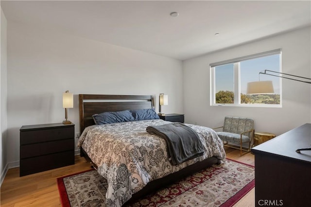 bedroom with hardwood / wood-style flooring