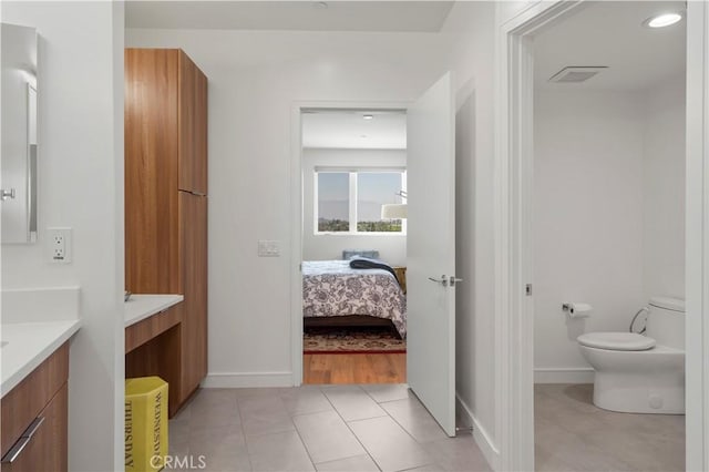 bathroom featuring tile patterned floors, vanity, and toilet