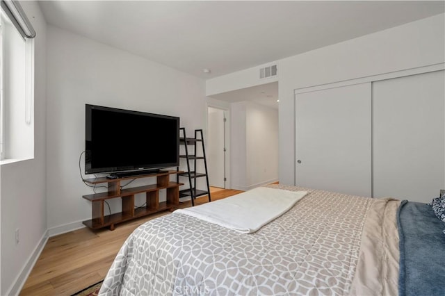 bedroom featuring hardwood / wood-style flooring and a closet