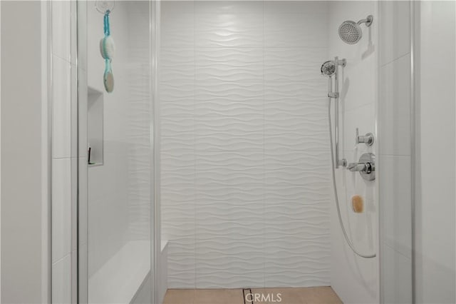 bathroom featuring a shower with door