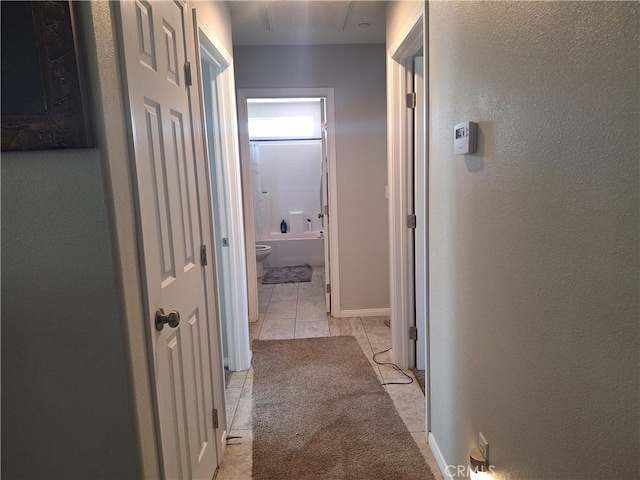 corridor with light tile patterned flooring