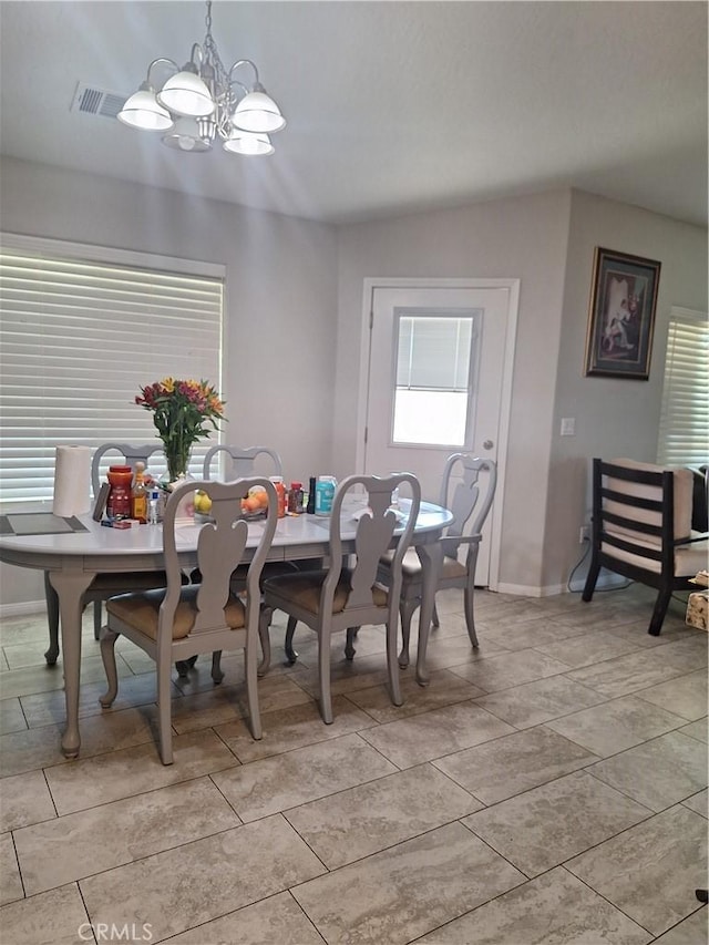 dining area featuring a chandelier