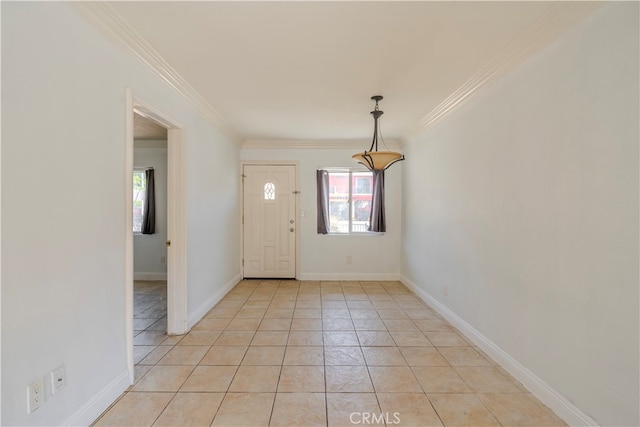 entrance foyer featuring crown molding and light tile patterned floors