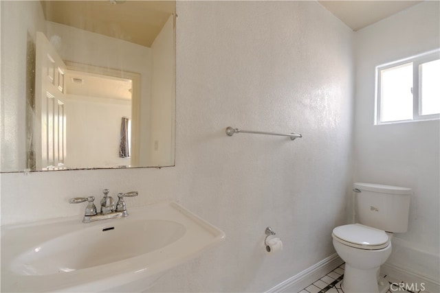 bathroom featuring sink and toilet