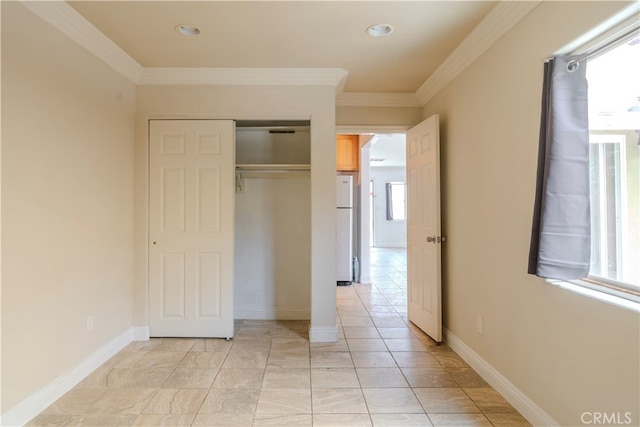 unfurnished bedroom featuring a closet, ornamental molding, and white fridge