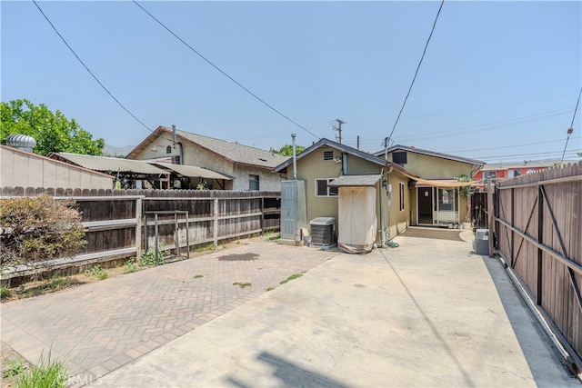 back of house with a patio area and central air condition unit