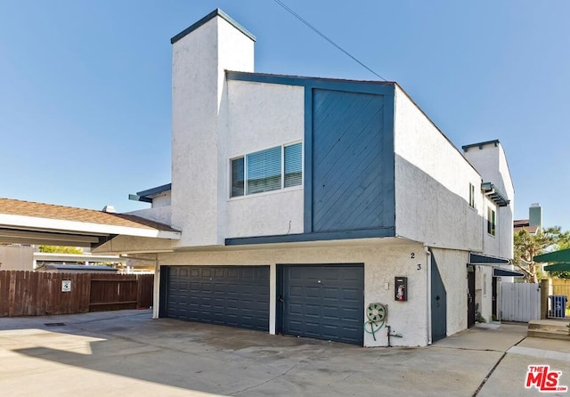 rear view of property featuring a garage