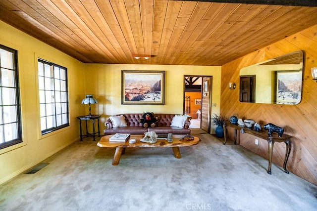 living room featuring wood walls, wooden ceiling, and carpet floors