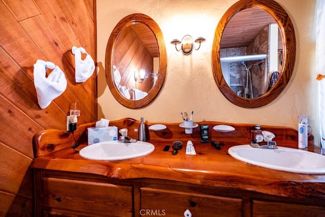 bathroom featuring wood walls and vanity