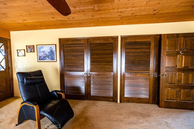 living area with light colored carpet and wooden ceiling