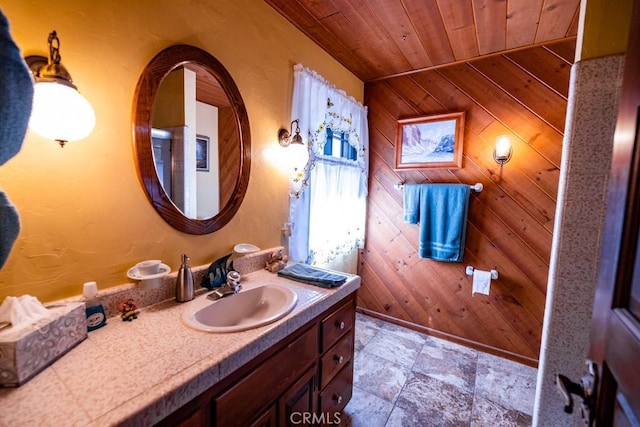 bathroom featuring vanity, wood walls, and wood ceiling