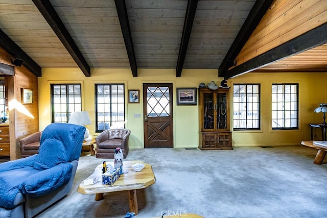 carpeted living room with lofted ceiling with beams, plenty of natural light, and wooden ceiling