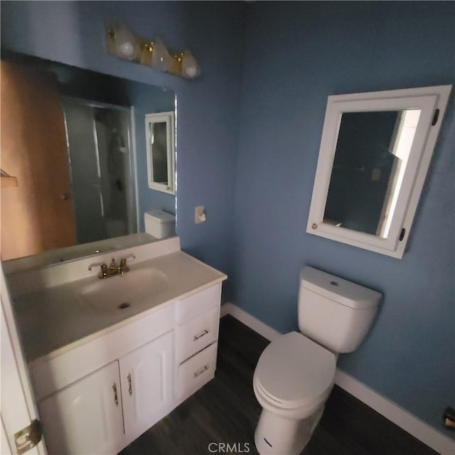 bathroom featuring hardwood / wood-style floors, vanity, and toilet