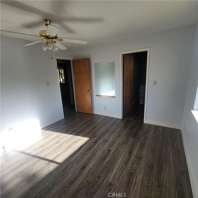 empty room with dark hardwood / wood-style flooring and ceiling fan