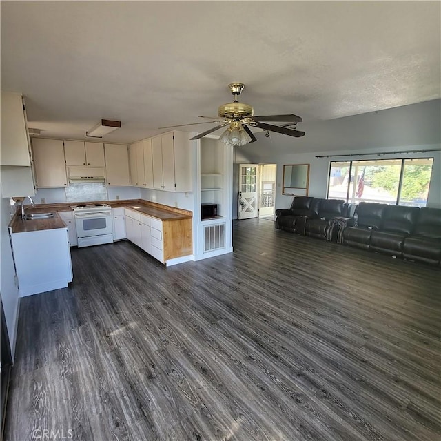 kitchen featuring dark wood-type flooring, white range, sink, ceiling fan, and white cabinetry