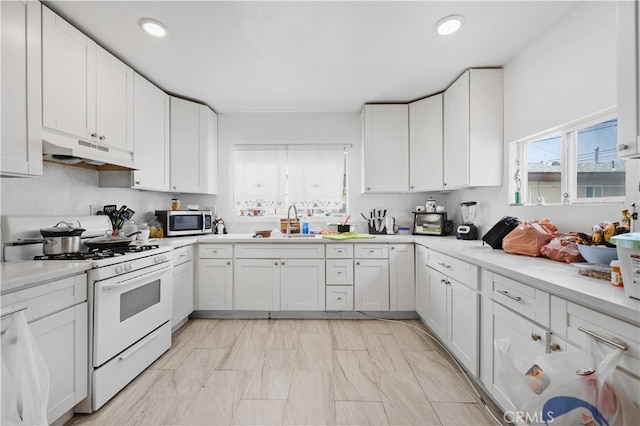 kitchen featuring white cabinets, sink, white range with gas cooktop, light tile floors, and custom exhaust hood