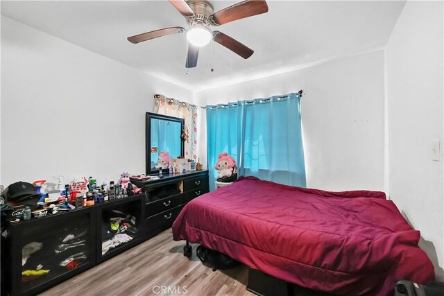 bedroom with ceiling fan and hardwood / wood-style floors