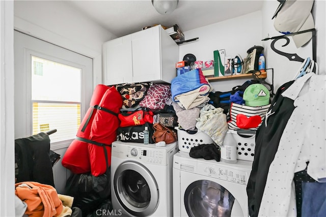 laundry area with washer and clothes dryer and cabinets