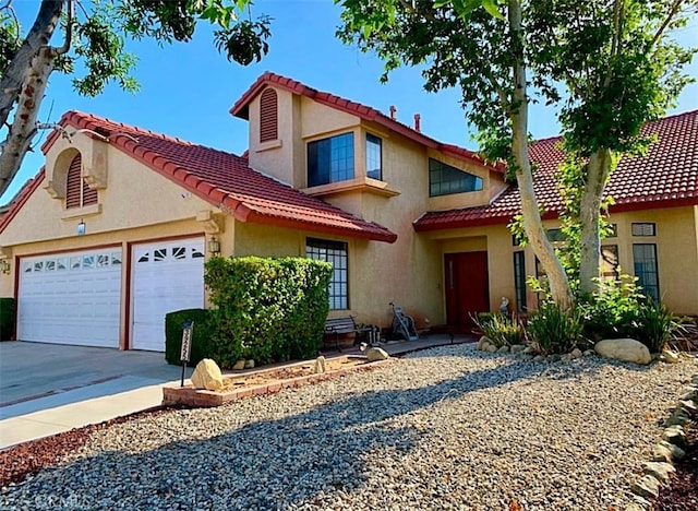 mediterranean / spanish house with a garage