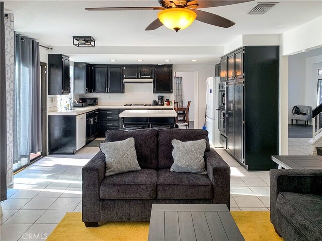 living room featuring ceiling fan and light tile patterned flooring