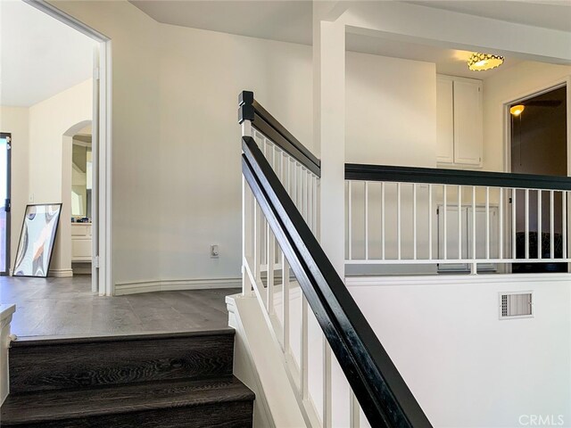 stairs featuring wood-type flooring