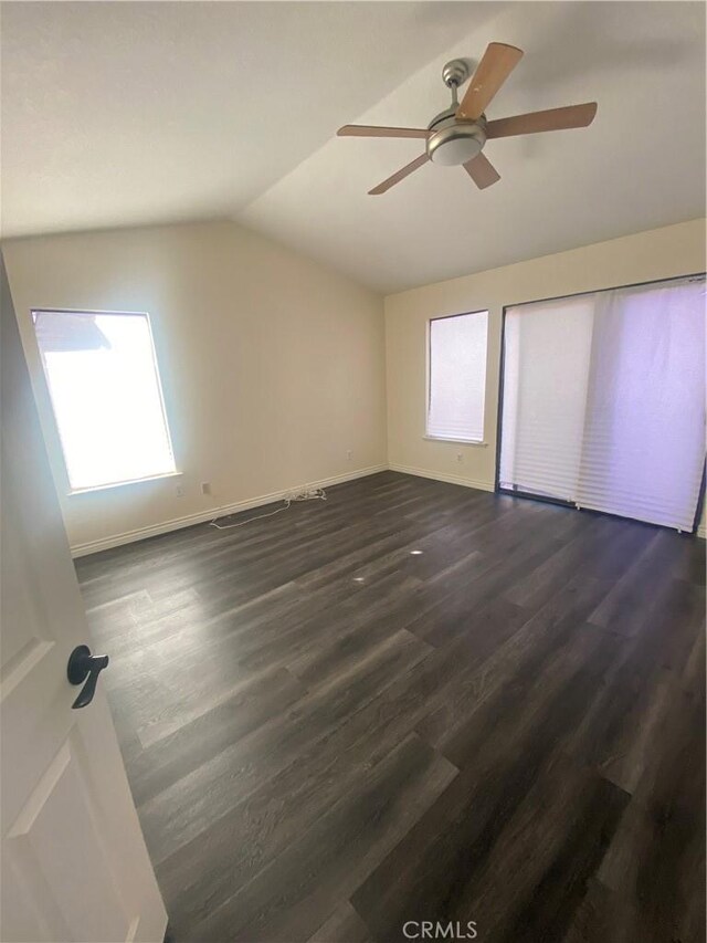 interior space featuring dark hardwood / wood-style floors, multiple windows, and ceiling fan