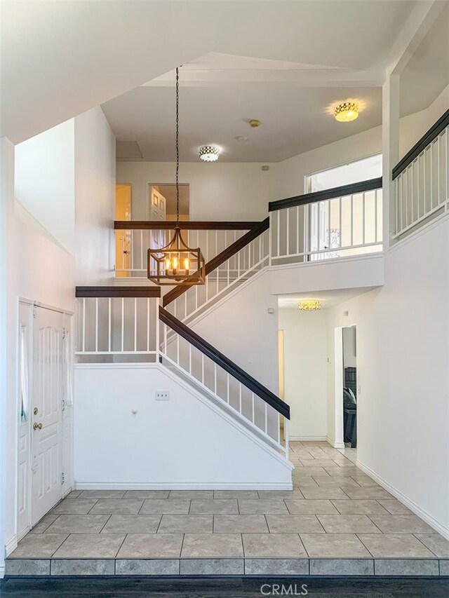 entrance foyer with a towering ceiling and a notable chandelier