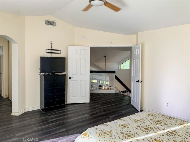 bedroom with lofted ceiling, ceiling fan, and dark wood-type flooring