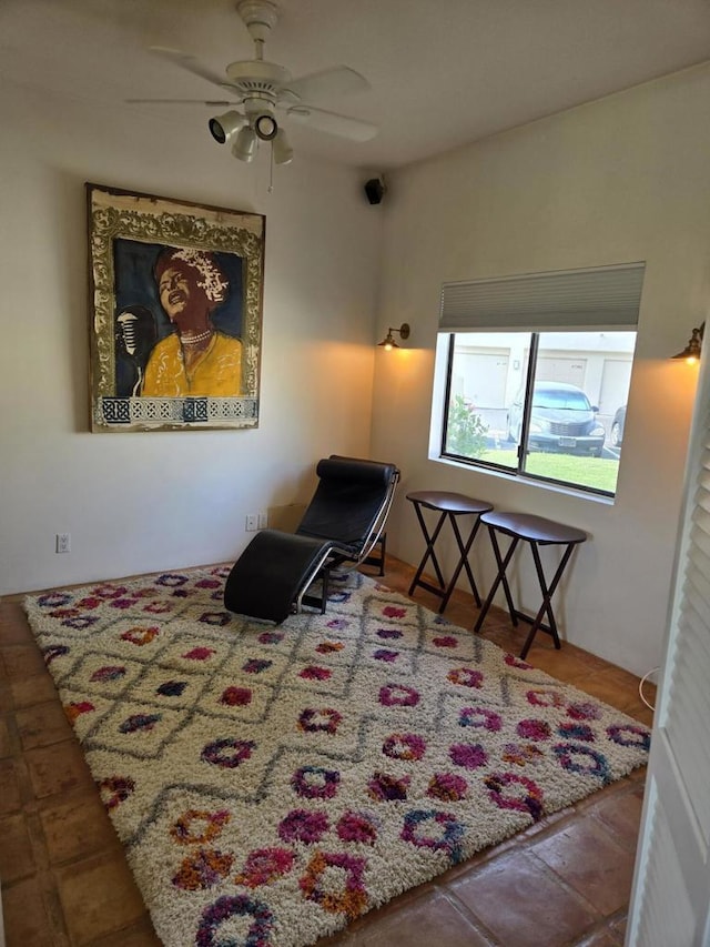 living area with ceiling fan