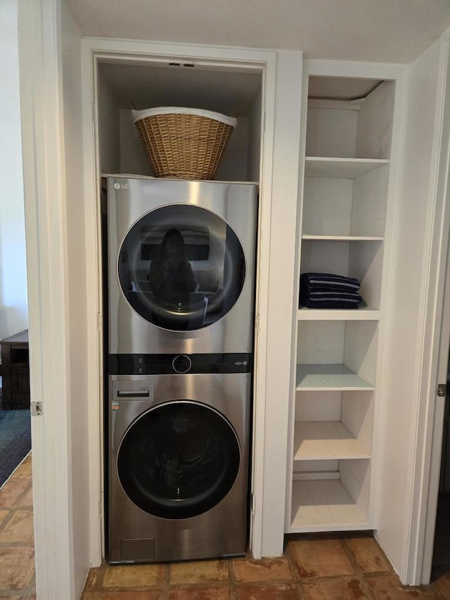 laundry room with stacked washer / drying machine