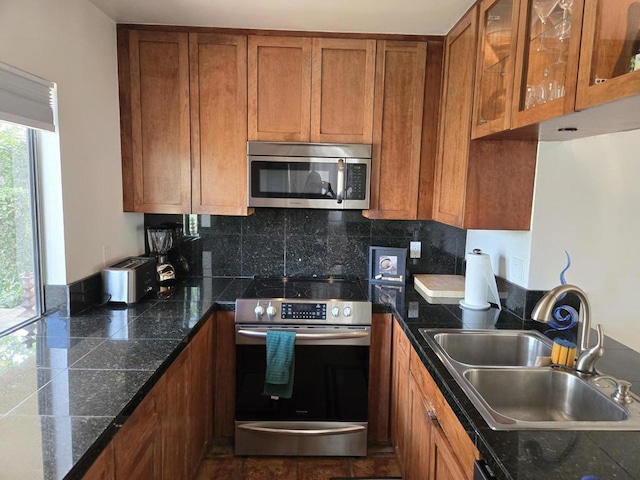 kitchen featuring backsplash, sink, and stainless steel appliances