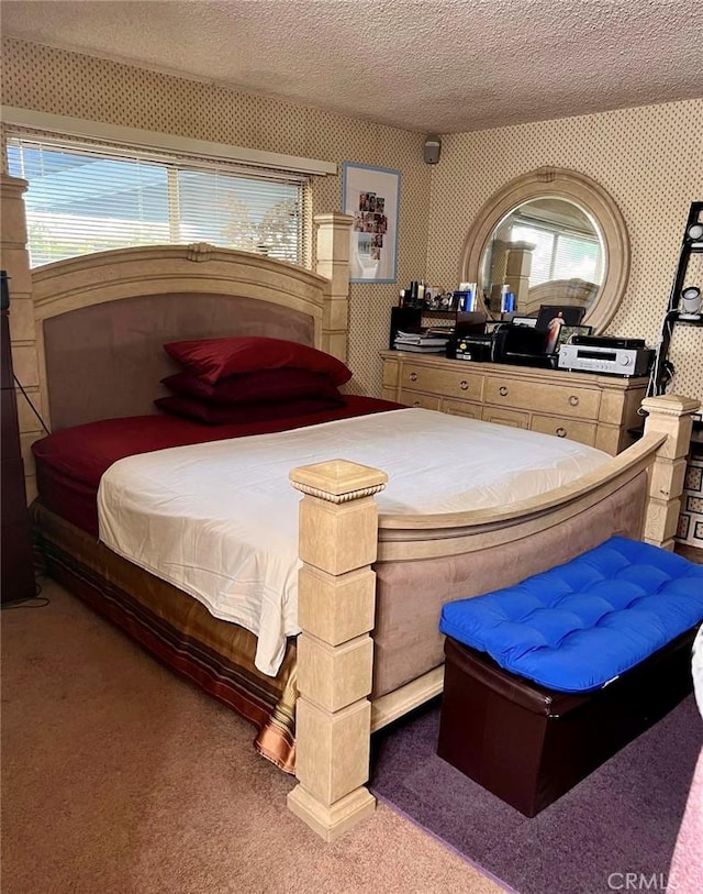 bedroom featuring carpet flooring and a textured ceiling