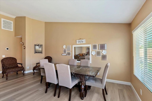 dining area with light hardwood / wood-style floors