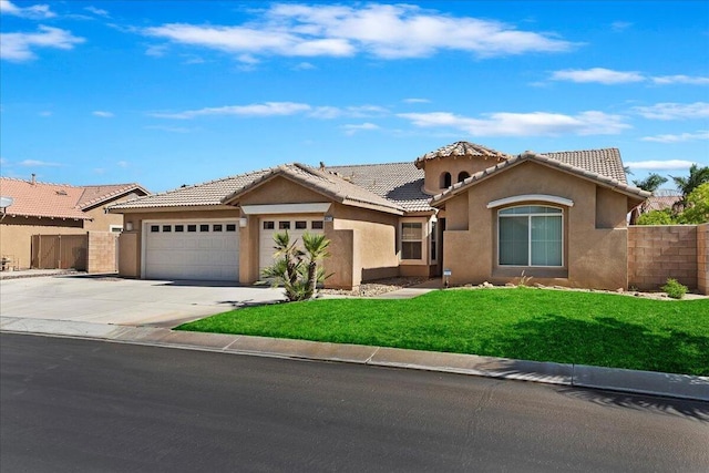 view of front of home with a garage and a front lawn