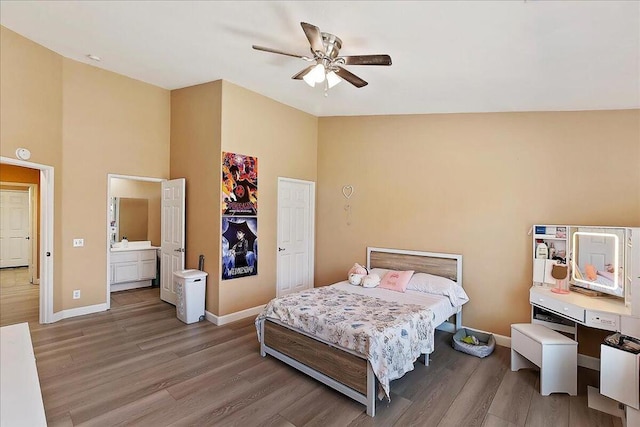 bedroom with light hardwood / wood-style floors, high vaulted ceiling, and ceiling fan