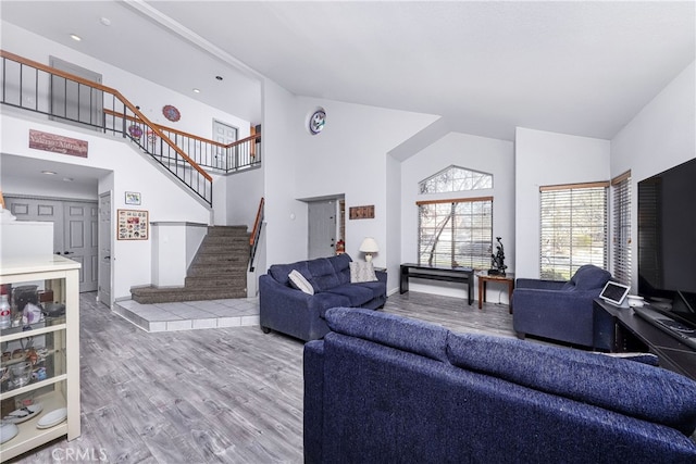 living room with hardwood / wood-style flooring and high vaulted ceiling