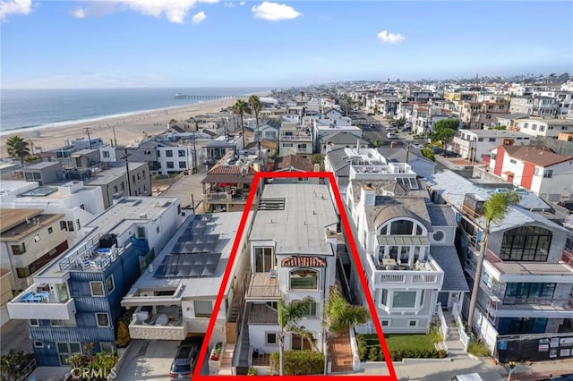 birds eye view of property featuring a water view and a beach view