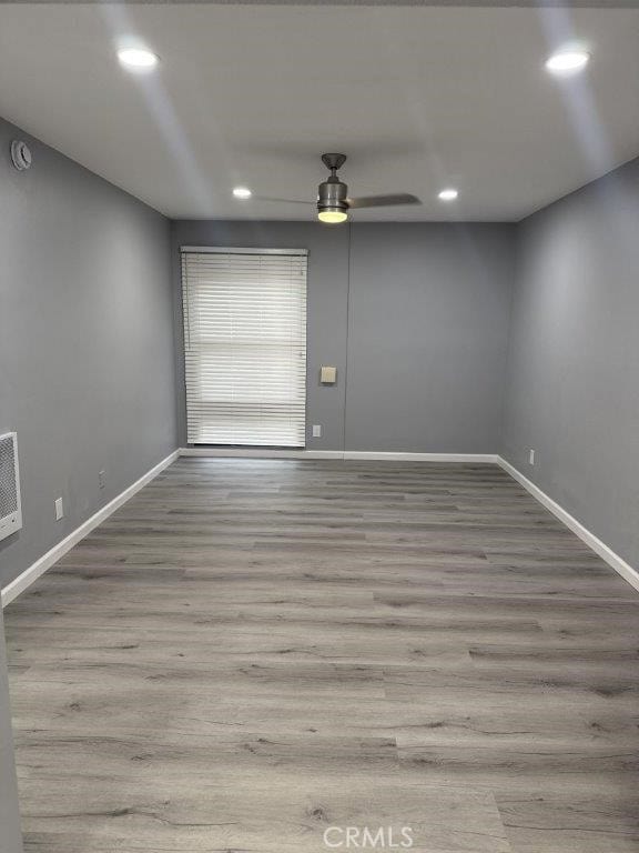 empty room featuring light hardwood / wood-style floors and ceiling fan