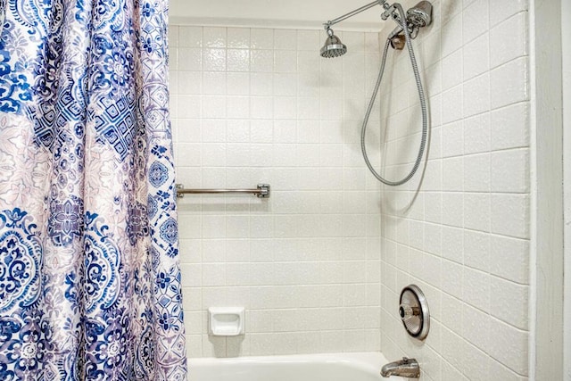 bathroom with shower / bathtub combination with curtain