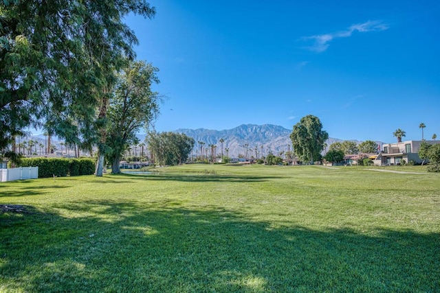 view of community featuring a mountain view and a lawn