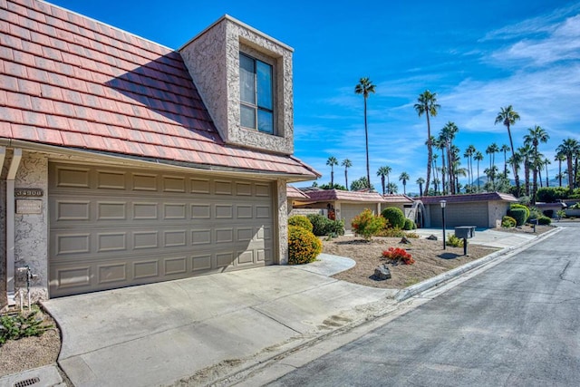 view of side of property with a garage