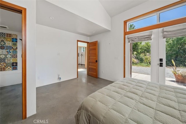 bedroom featuring concrete flooring and access to outside