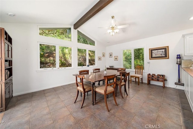 tiled dining room with ceiling fan and vaulted ceiling with beams