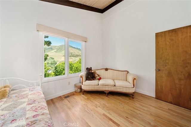 bedroom with hardwood / wood-style floors and wood ceiling