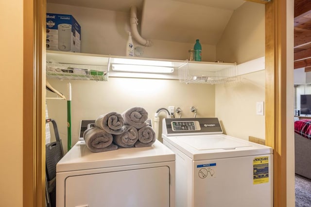 clothes washing area featuring separate washer and dryer