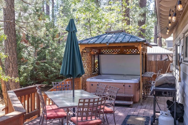 view of patio featuring a hot tub, area for grilling, and a gazebo