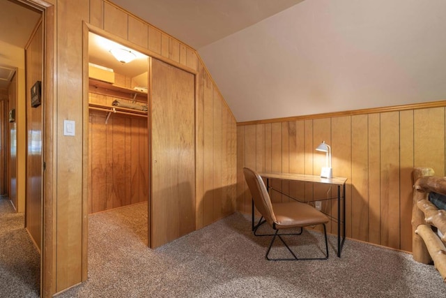 office featuring wooden walls, vaulted ceiling, and carpet flooring