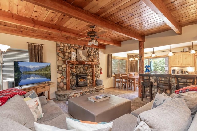 carpeted living room with ceiling fan with notable chandelier, beam ceiling, wooden ceiling, and a fireplace